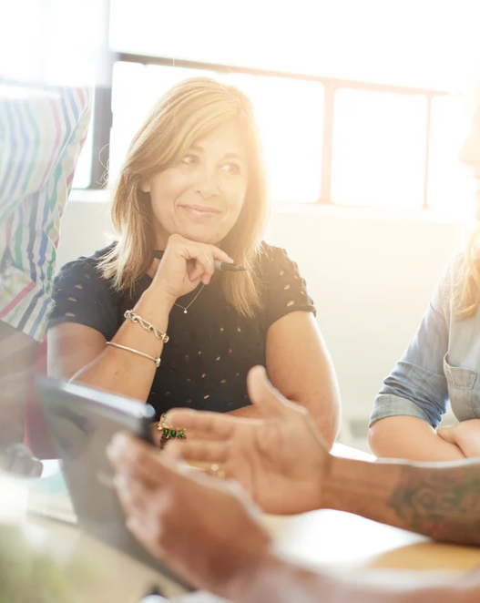 Unposed group of creative business people in an open concept office brainstorming their next project copy