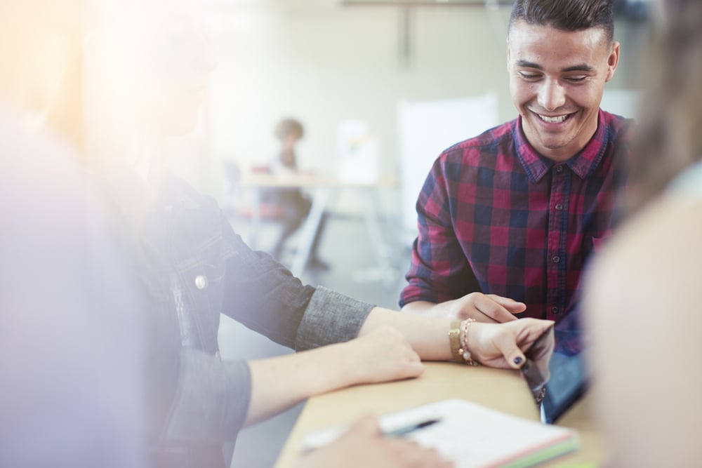 Unposed group of creative business people in an open concept office brainstorming their next project.-1